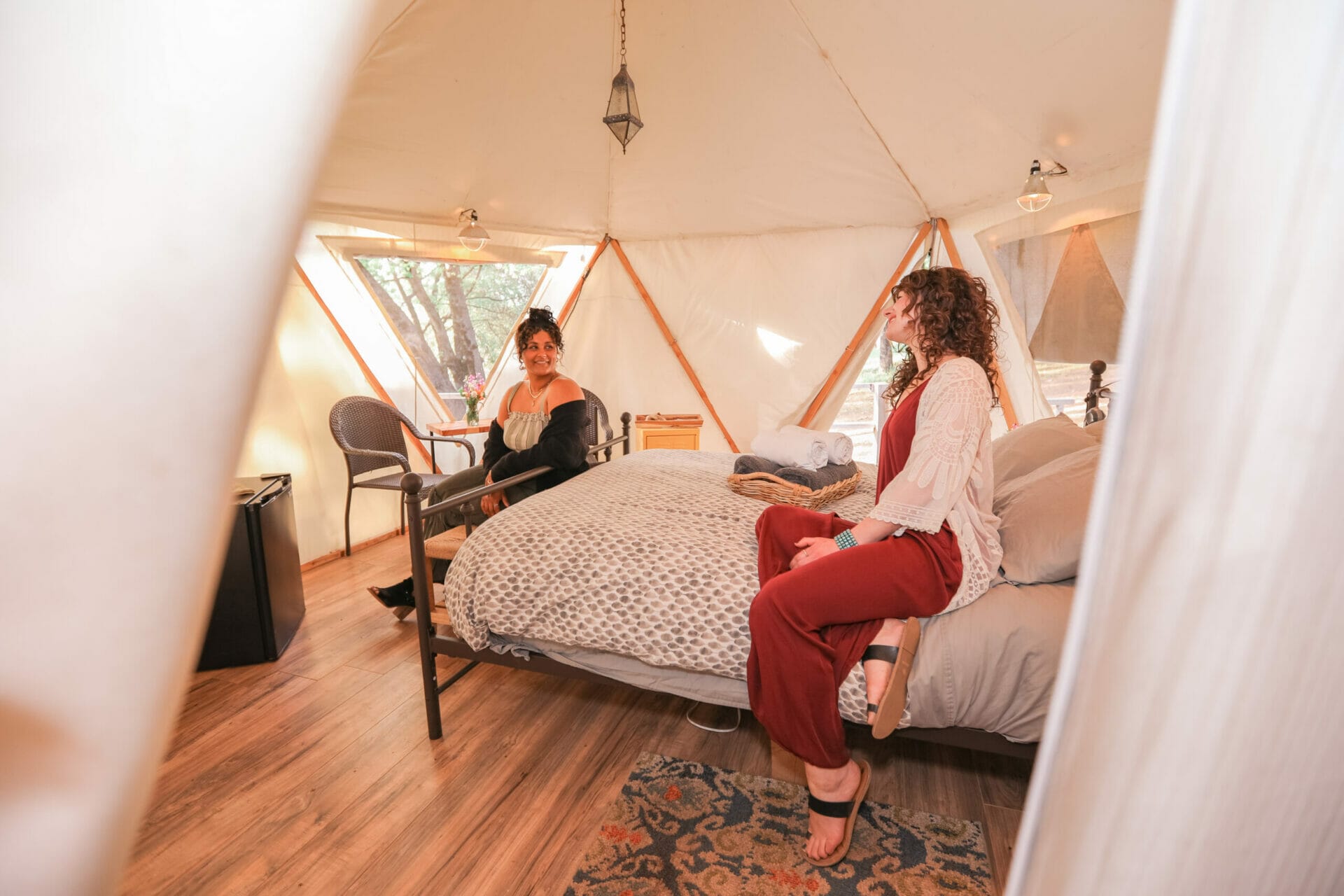 Reverie retreat inside yurt two woman speaking