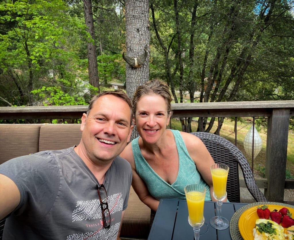 Tamara & Ramon on the deck – “Meet the humans behind Reverie Retreat—our favorite place to live, work, and share with guests.”