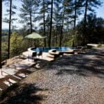 outdoors pool during the summer with bathing chairs and umbrella