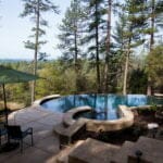 outdoors pool and hot tub in the middle of the woods