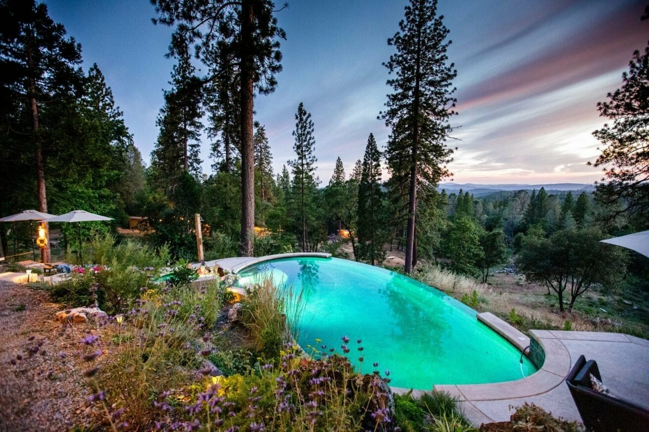 Reverie retreat outdoor pool in the middle of the woods during the evening